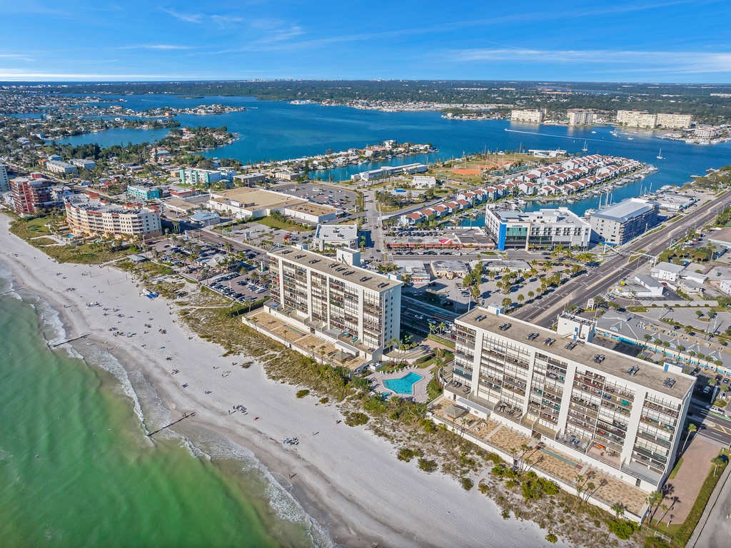 Spectacular beachfront property positioned directly on pristine white sand with bay waters beyond.