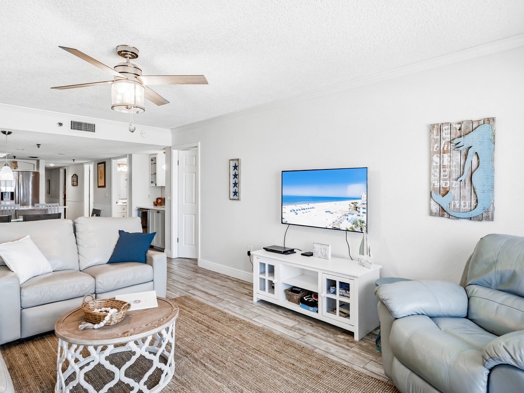 Relax in your bright coastal living room with plush seating, modern TV, and nautical touches that create the perfect beach getaway atmosphere.
