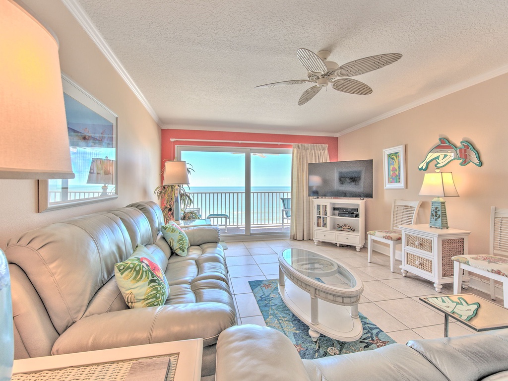 Sink into soft leather seating while ocean breezes flow through your bright, coastal living room with stunning sea views.