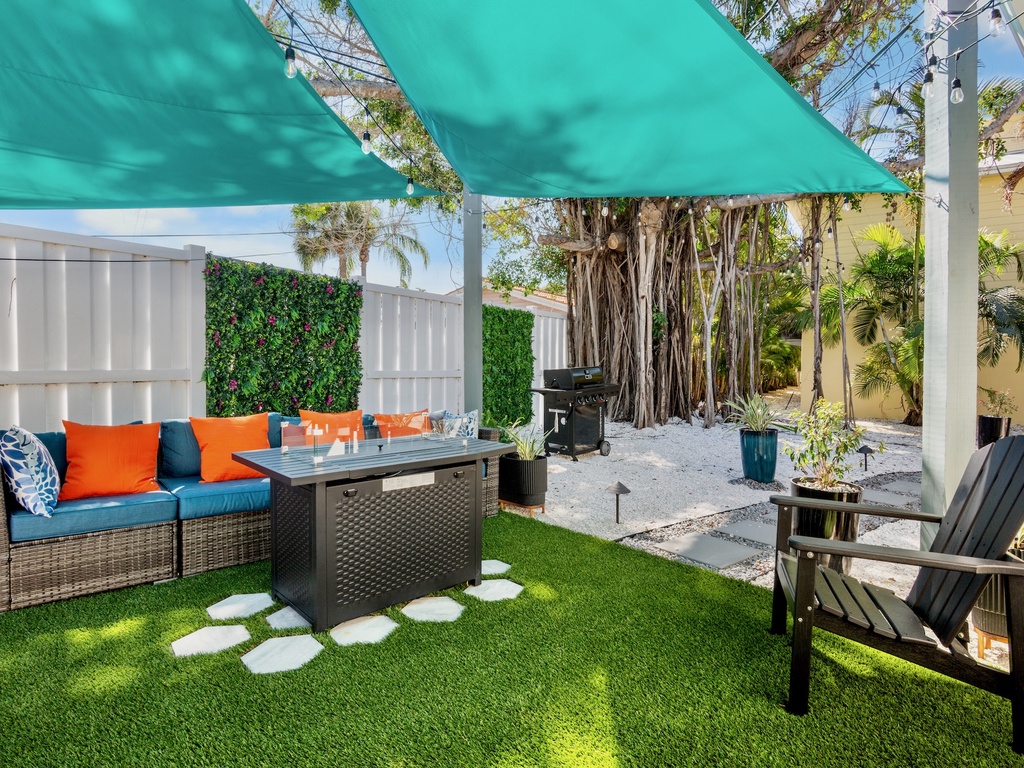 Shared backyard with comfortable seating and BBQ grill
