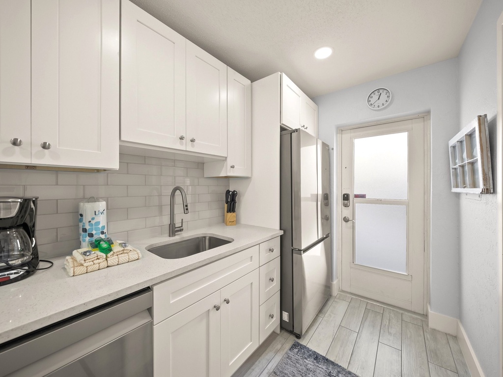 Your bright, modern kitchen features crisp white cabinets, stainless appliances, and everything you need for home-cooked meals.