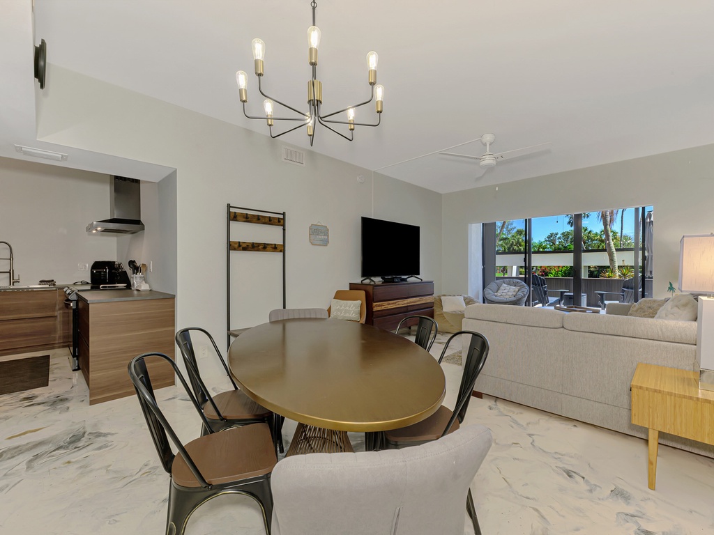 Your spacious open-plan living area flows seamlessly from kitchen to dining, perfect for gathering with loved ones under elegant lighting.