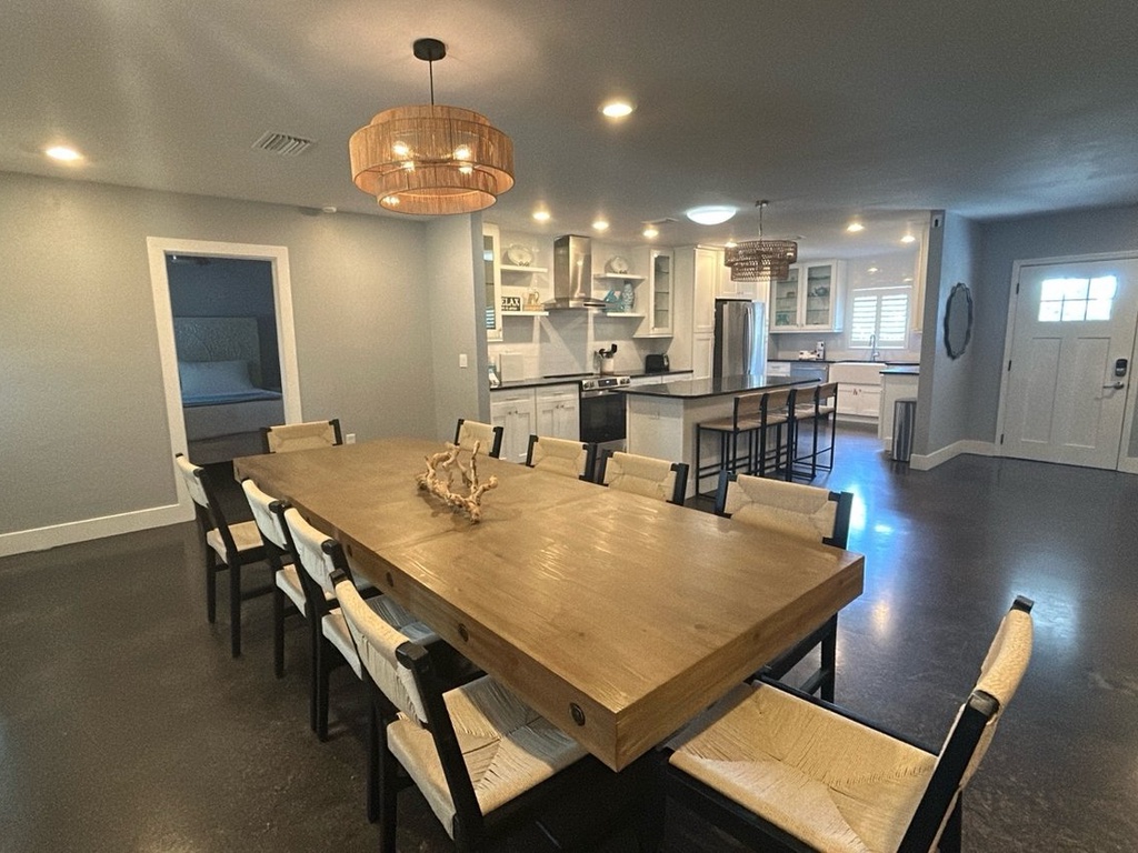 Gather around this stunning dining table where memorable meals and conversations await your group in this beautiful open-concept space.