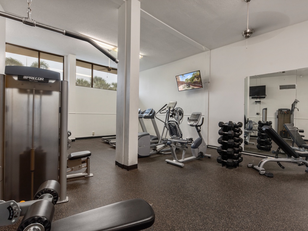 Your fitness goals await in this well-equipped gym, complete with modern cardio machines, free weights, and strength training equipment for your daily workout.