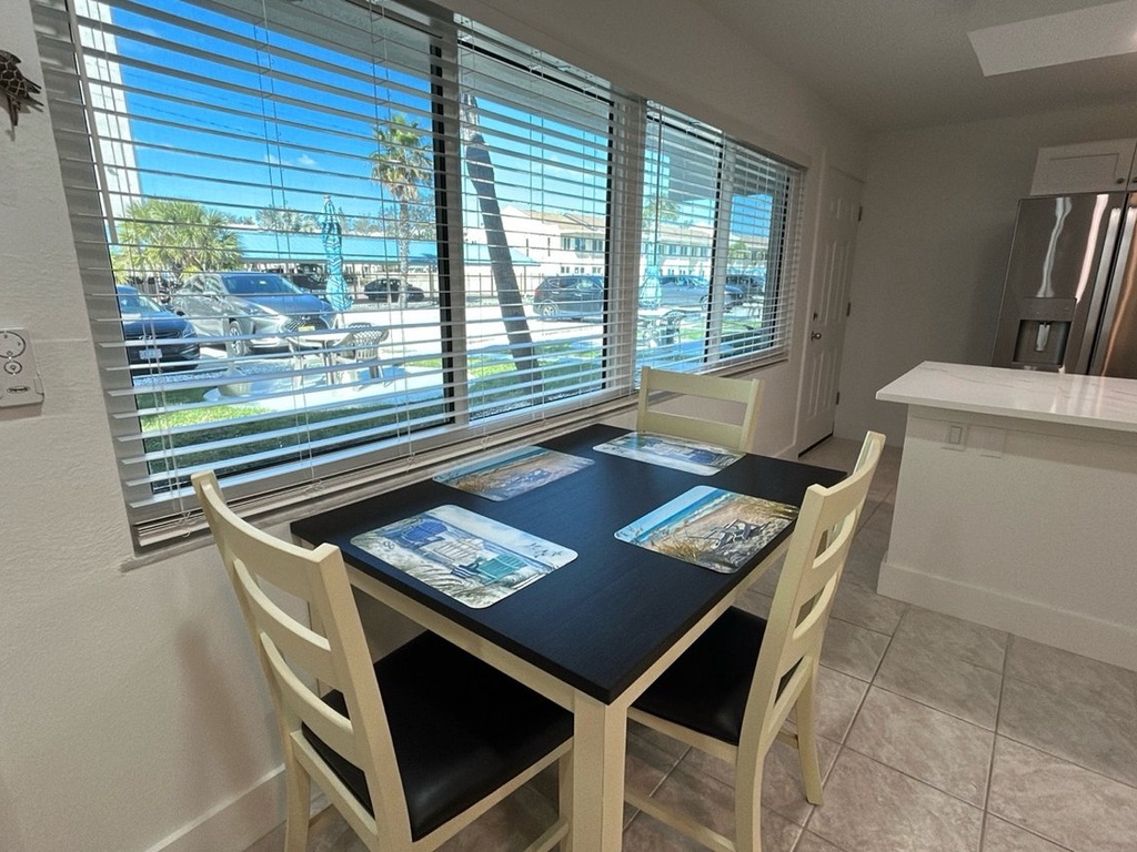 Your bright dining nook offers the perfect spot for morning coffee and planning adventures, with natural light streaming through the blinds.