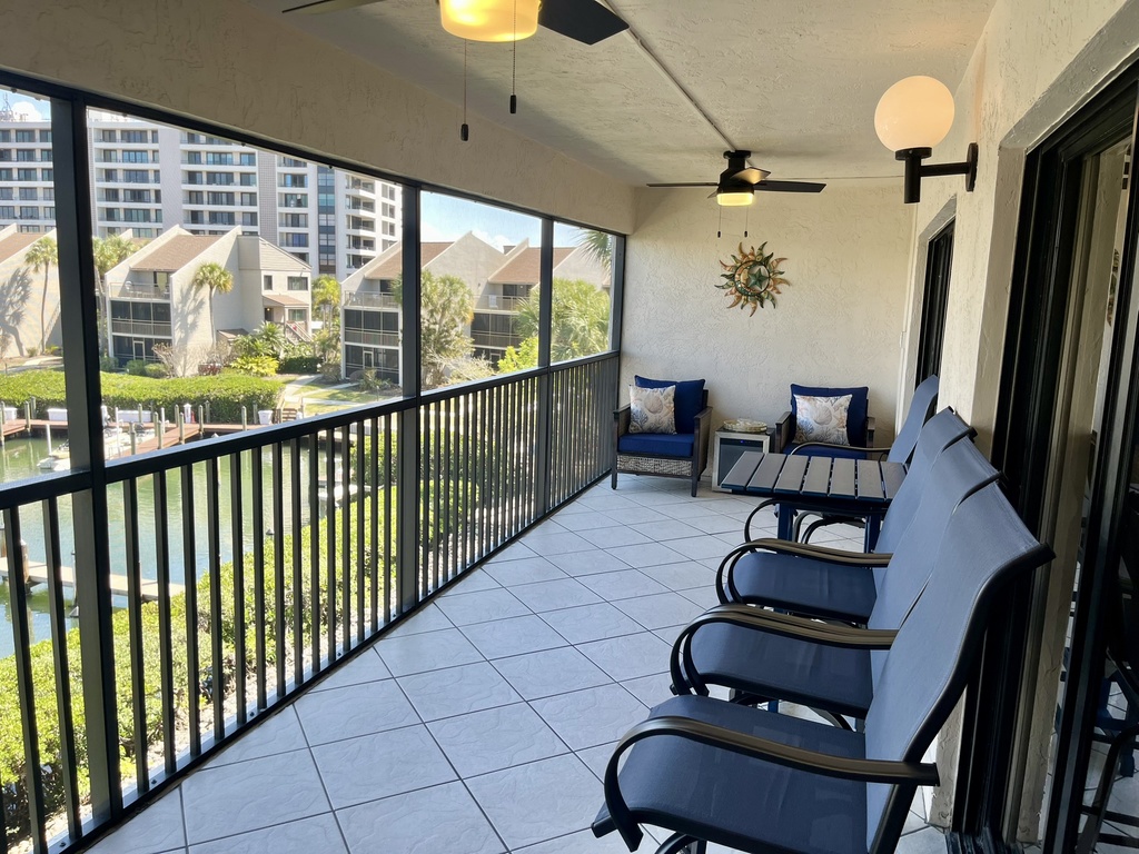 Unwind on your private screened balcony with plush seating and waterfront views—perfect for morning coffee or sunset cocktails.