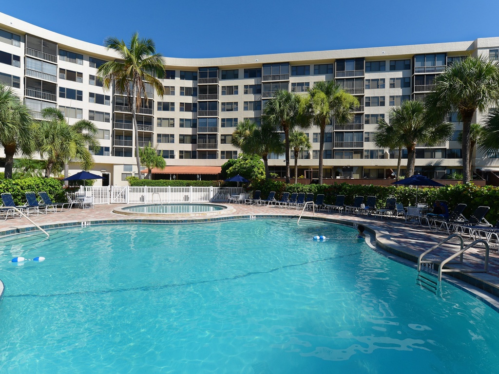 Take a refreshing dip in the crystal-clear pool surrounded by swaying palms and comfortable loungers for your ultimate relaxation.
