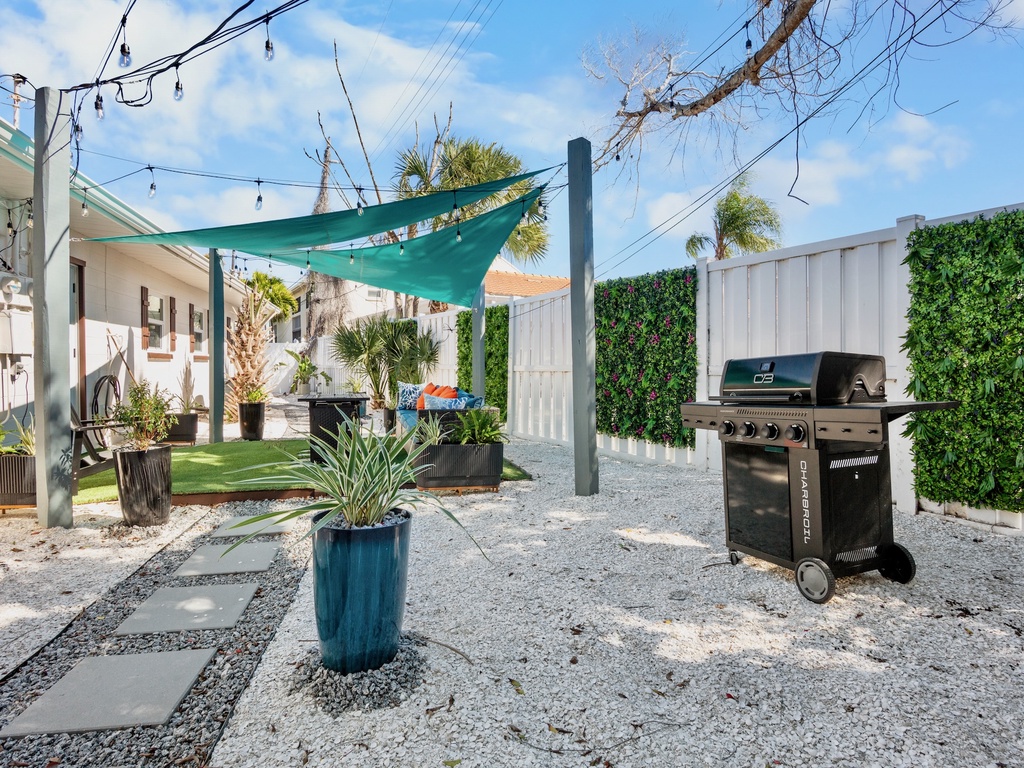 Shared backyard with comfortable seating and BBQ grill
