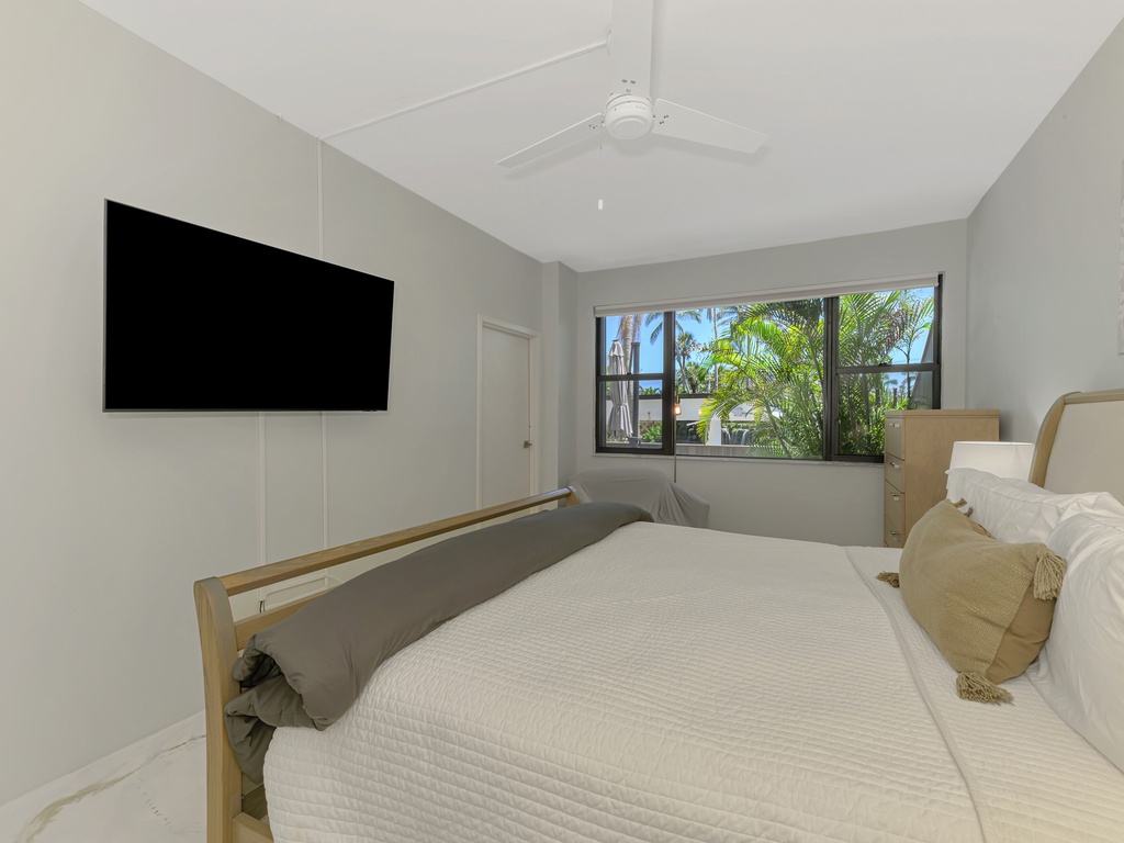 Drift off to sleep in your modern sanctuary with tropical views through the window and entertainment at your fingertips.