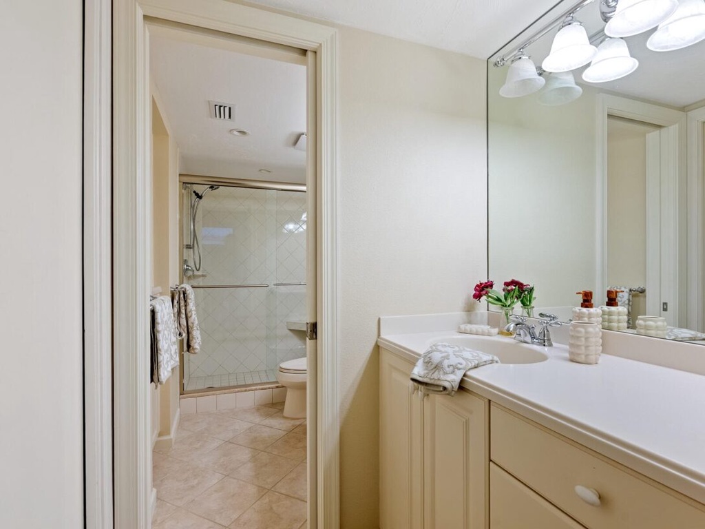 Your spacious bathroom features elegant dual vanities and a separate shower room, perfect for your morning routine.