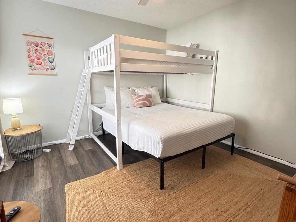 Second Bedroom features a unique bunk bed configuration with a full bed below and twin above, perfect for accommodating multiple guests comfortably.
