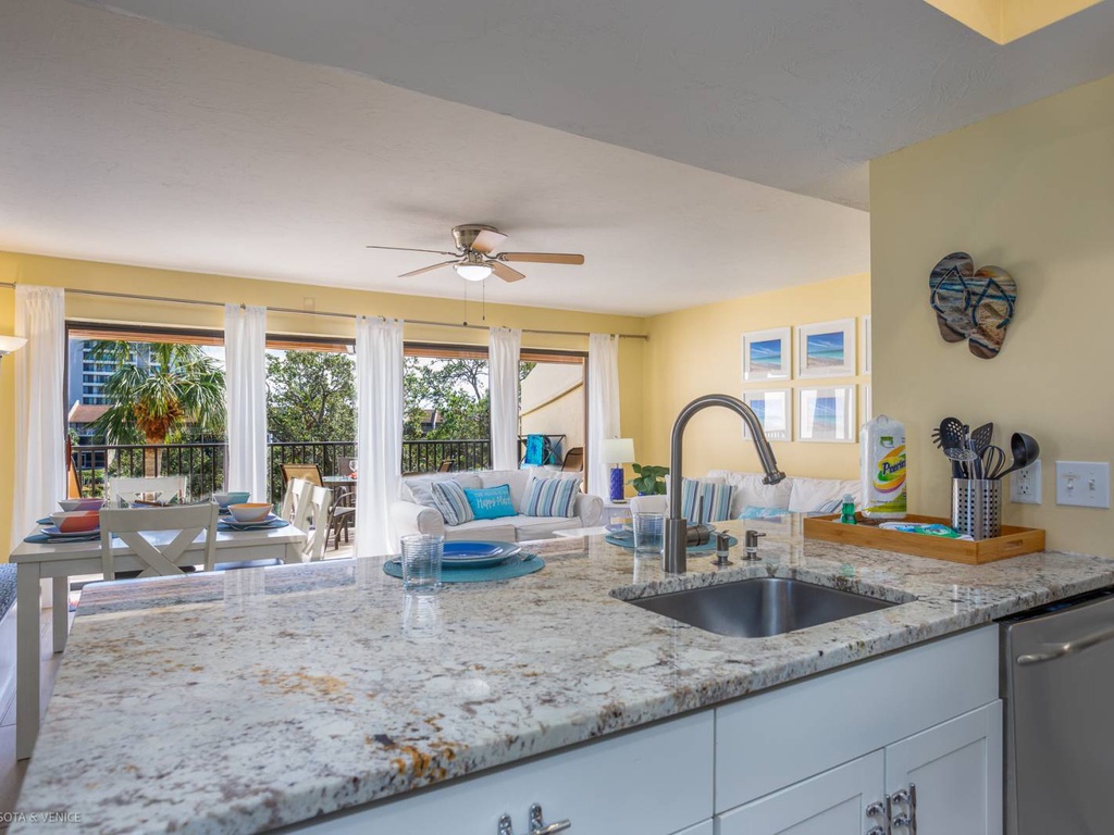 Your spacious kitchen flows into the bright living area, where granite countertops and modern appliances make cooking a joy while staying connected to your guests.