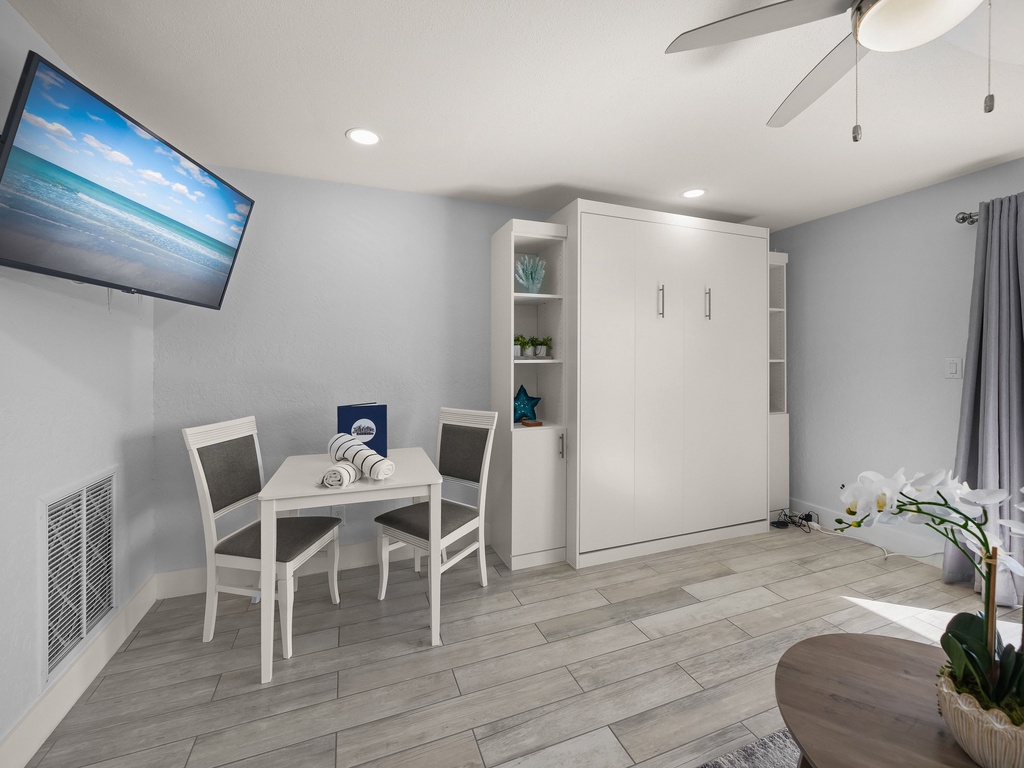 Your modern studio features a Murphy bed, dining nook, and wall-mounted TV for comfortable relaxing after exploring.