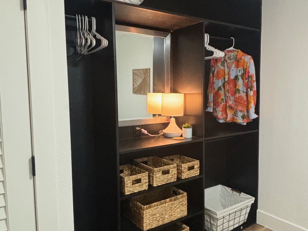 Your spacious walk-in closet features organized shelving, hanging rods, and wicker storage baskets to keep your belongings perfectly arranged.