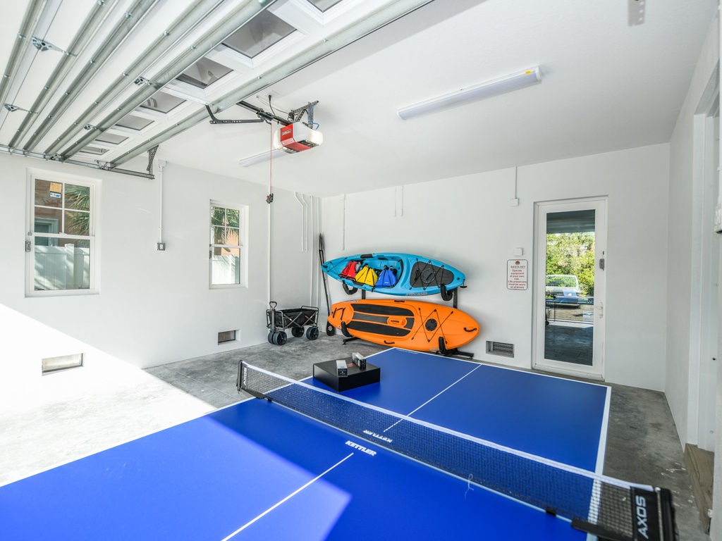 Garage area with ping pong table, kayak, and paddleboard