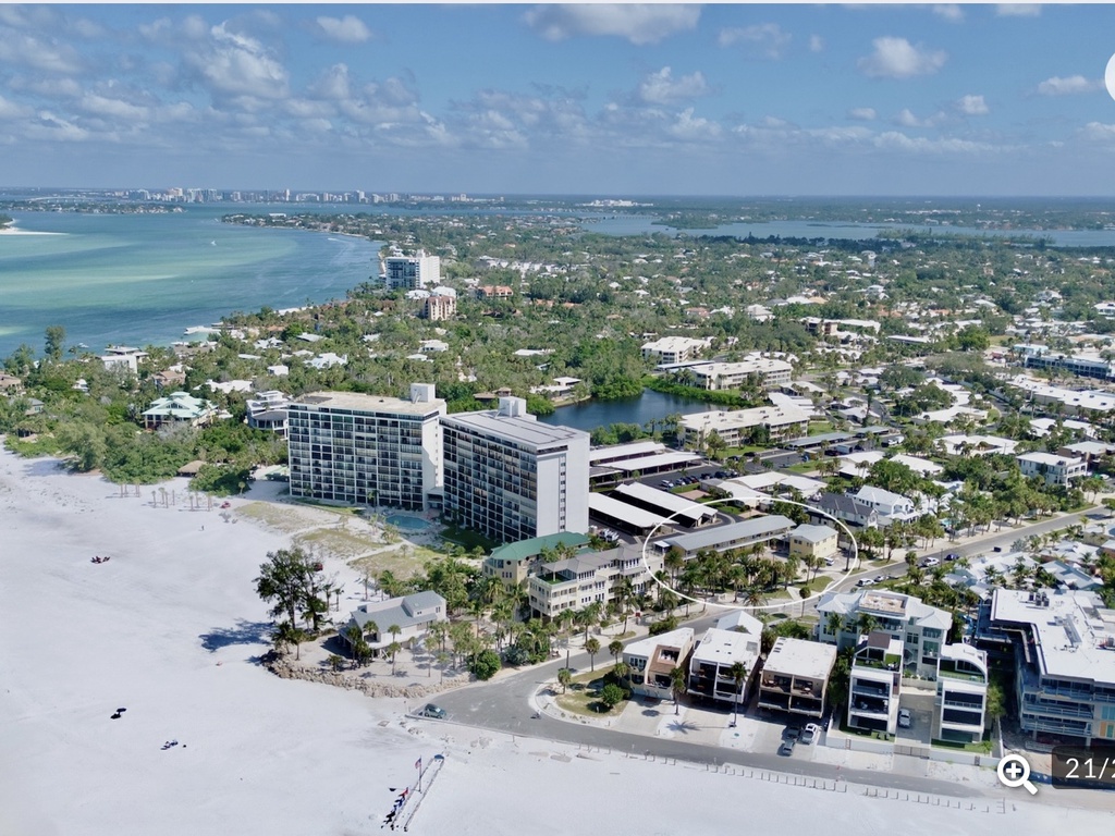 Stunning beachfront property offers direct beach access and panoramic coastal views in this vibrant waterfront community.