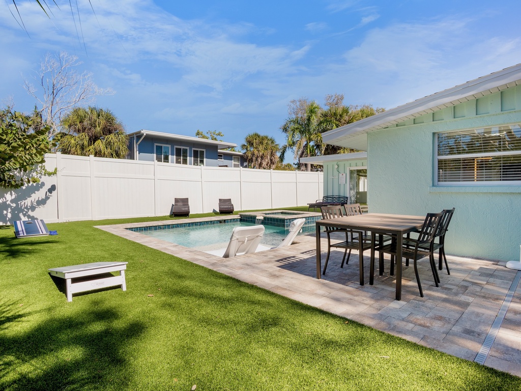 Your private backyard oasis features a sparkling pool, outdoor dining