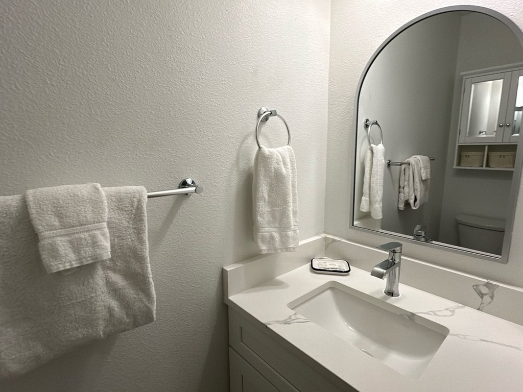 Step into your private bathroom retreat with plush towels, elegant marble countertops, and thoughtful amenities awaiting your arrival.