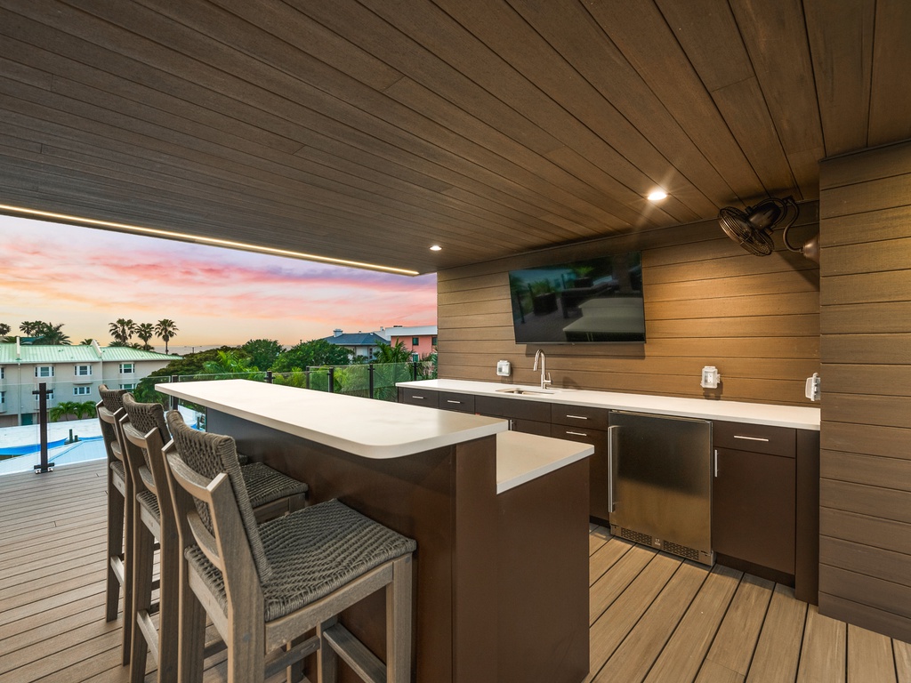 Rooftop bar area with TV for entertainment