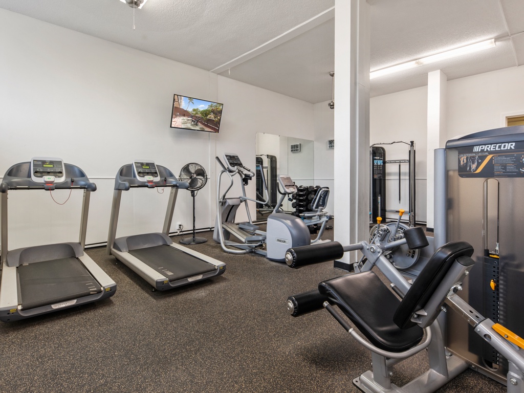 Stay active during your getaway in this well-equipped fitness center featuring treadmills, ellipticals, and strength training equipment for your daily workout routine.