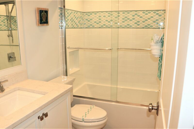 Hallway bathroom with tub and shower