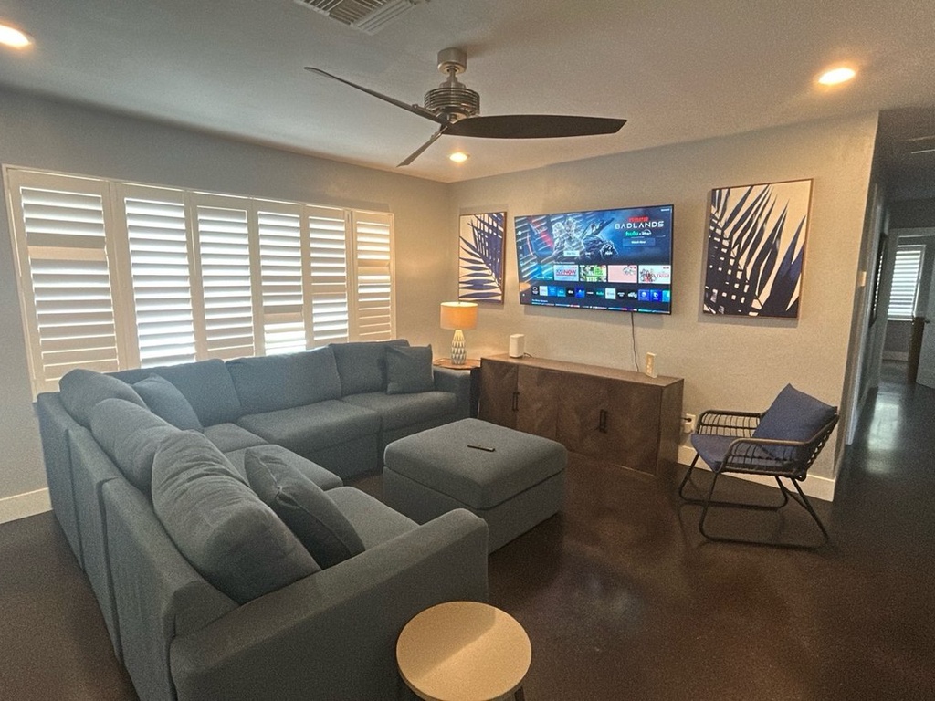 Sink into your plush sectional while enjoying your favorite shows on the large smart TV in this stylish living room.