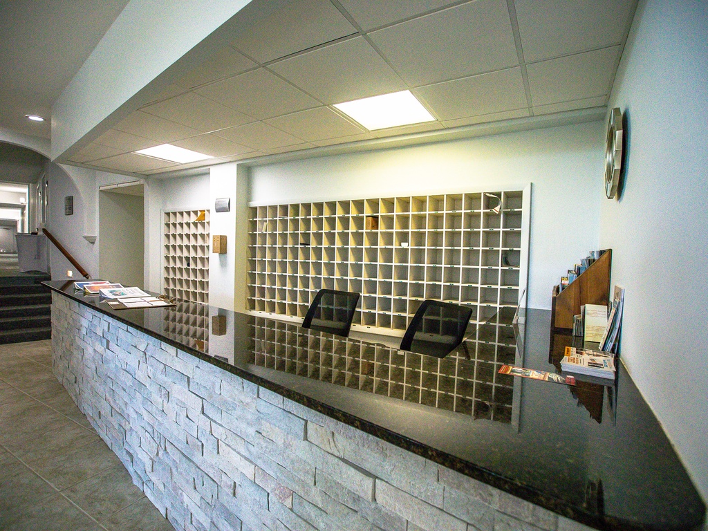 Modern reception desk with organized mail sorting system ensures smooth check-in and seamless communication throughout your stay.
