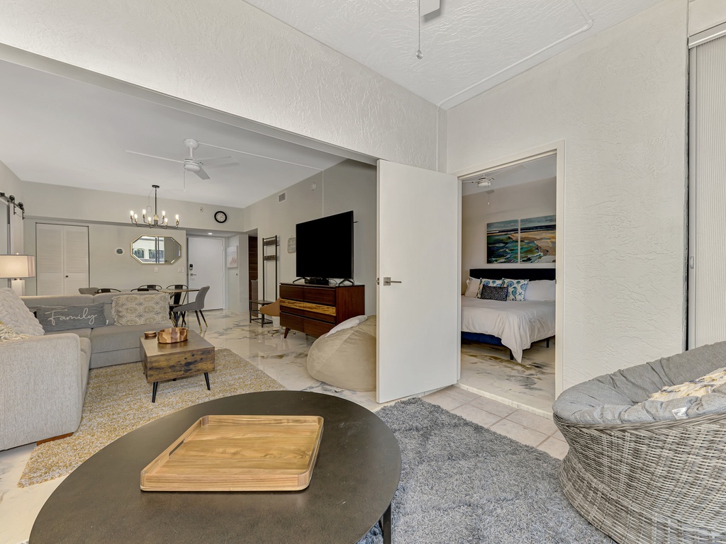 Relax in your open-plan living space with stylish furnishings, modern entertainment center, and seamless flow to your private bedroom sanctuary.