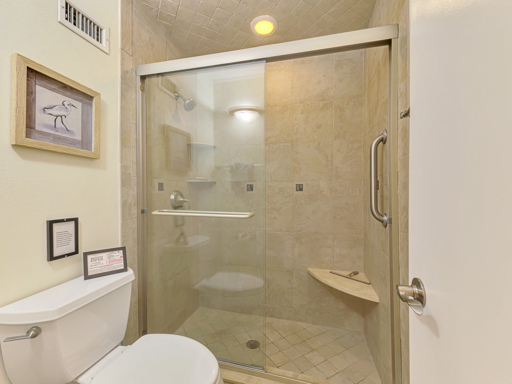 Your private bathroom features a spacious walk-in shower with glass doors, perfect for refreshing after your adventures.