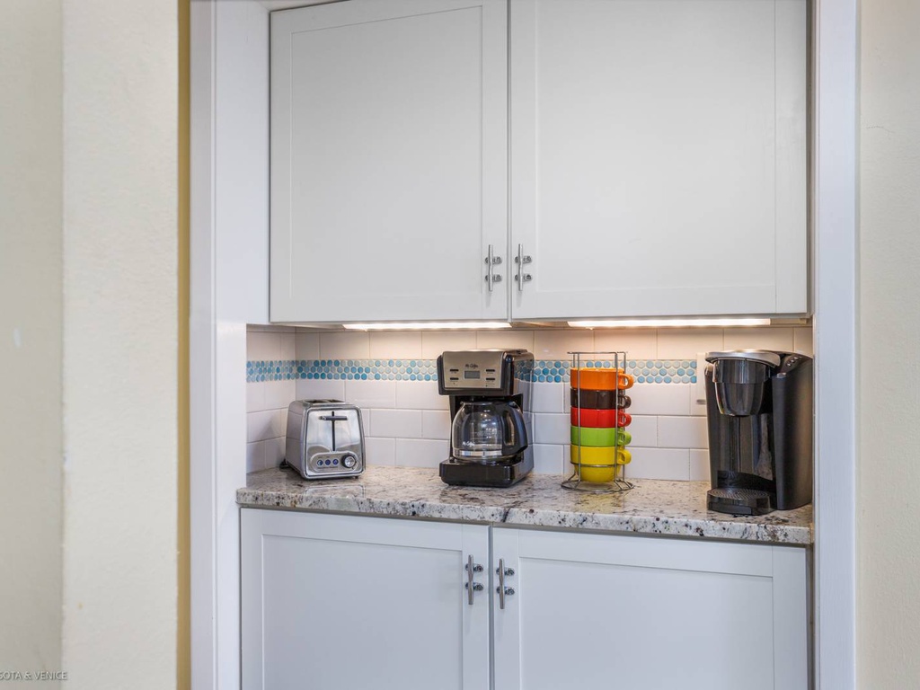 Start your mornings right with this convenient coffee station featuring fresh brewing options and cheerful colorful mugs ready for your perfect cup.