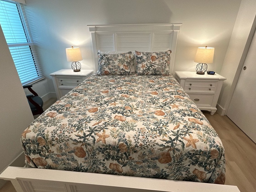 Drift into dreamland in your serene bedroom, complete with plush linens, warm bedside lighting, and calming floral patterns.