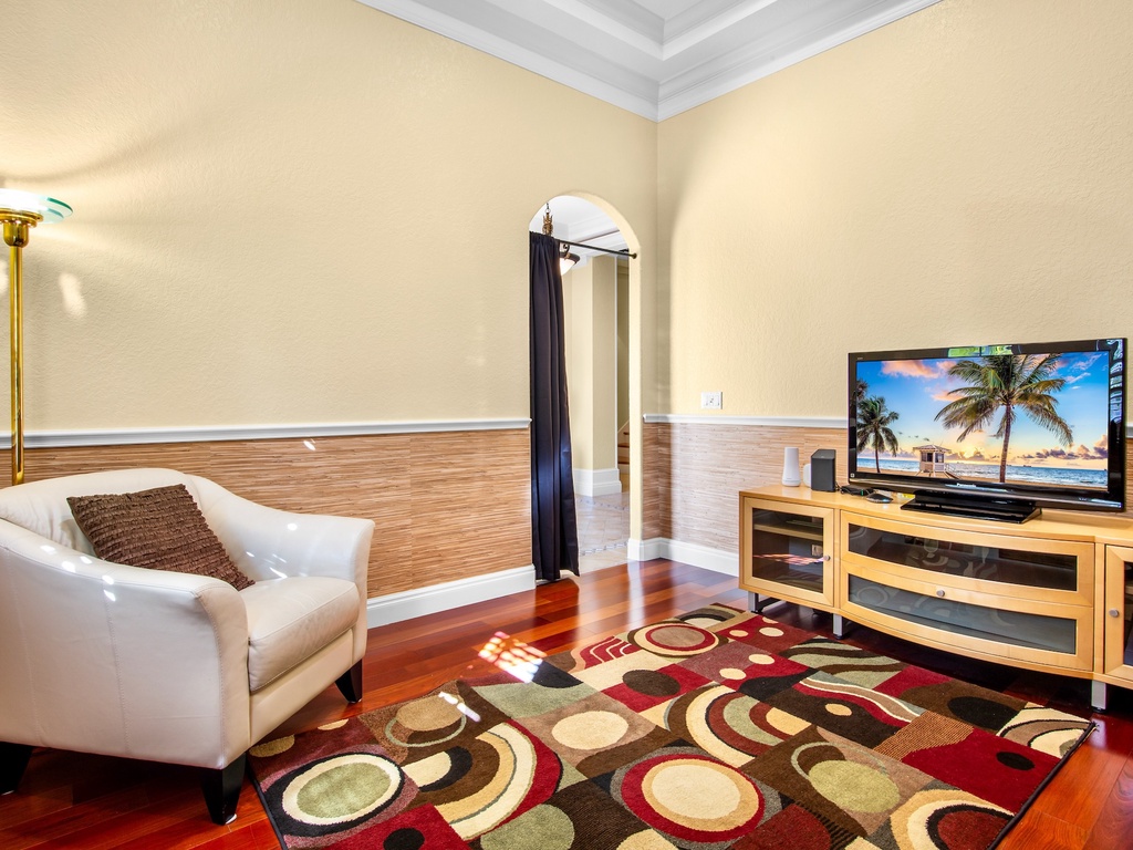 Private office with elegant plush seating and TV