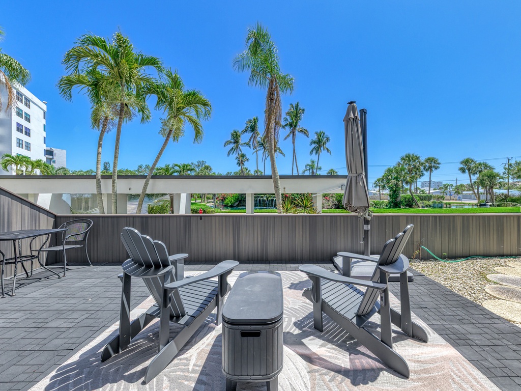 Soak up Florida sunshine on your private patio, where Adirondack chairs and tropical palm views create the perfect outdoor retreat.