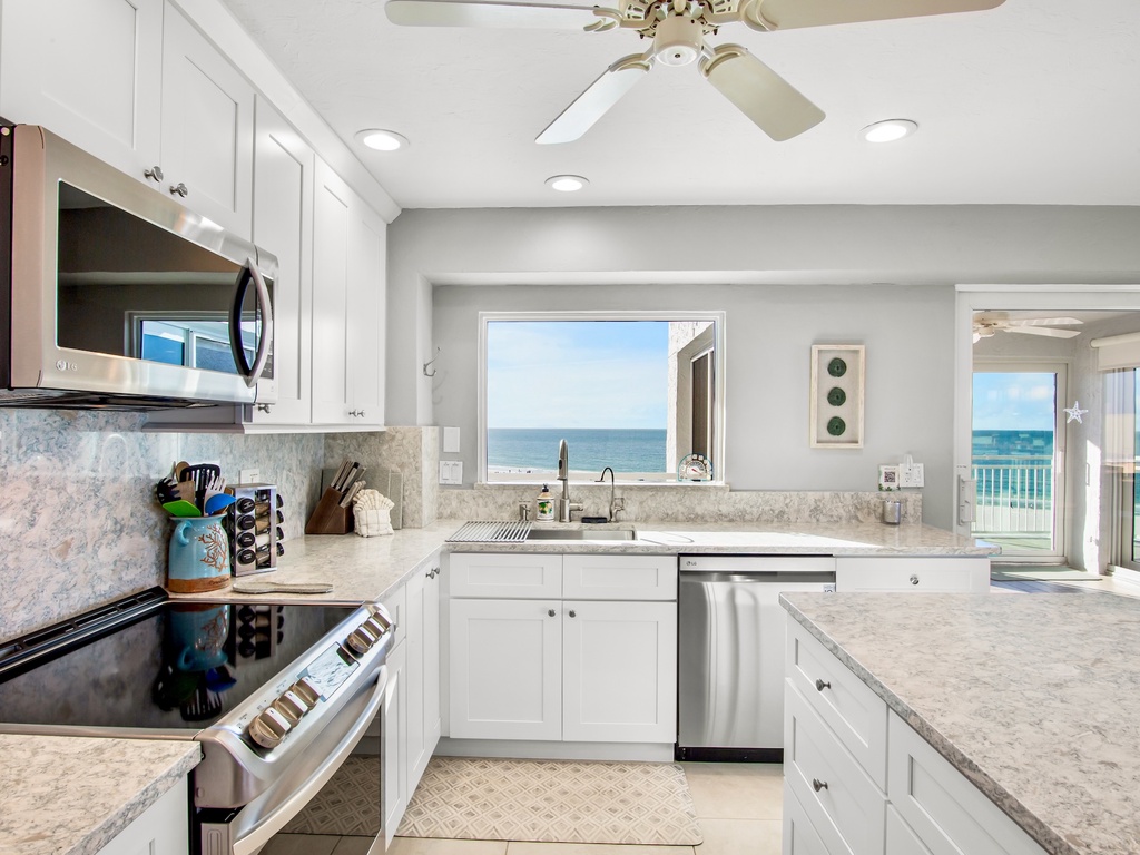 Cook with stunning ocean views through your kitchen window, where marble countertops and modern appliances make meal prep a joy.
