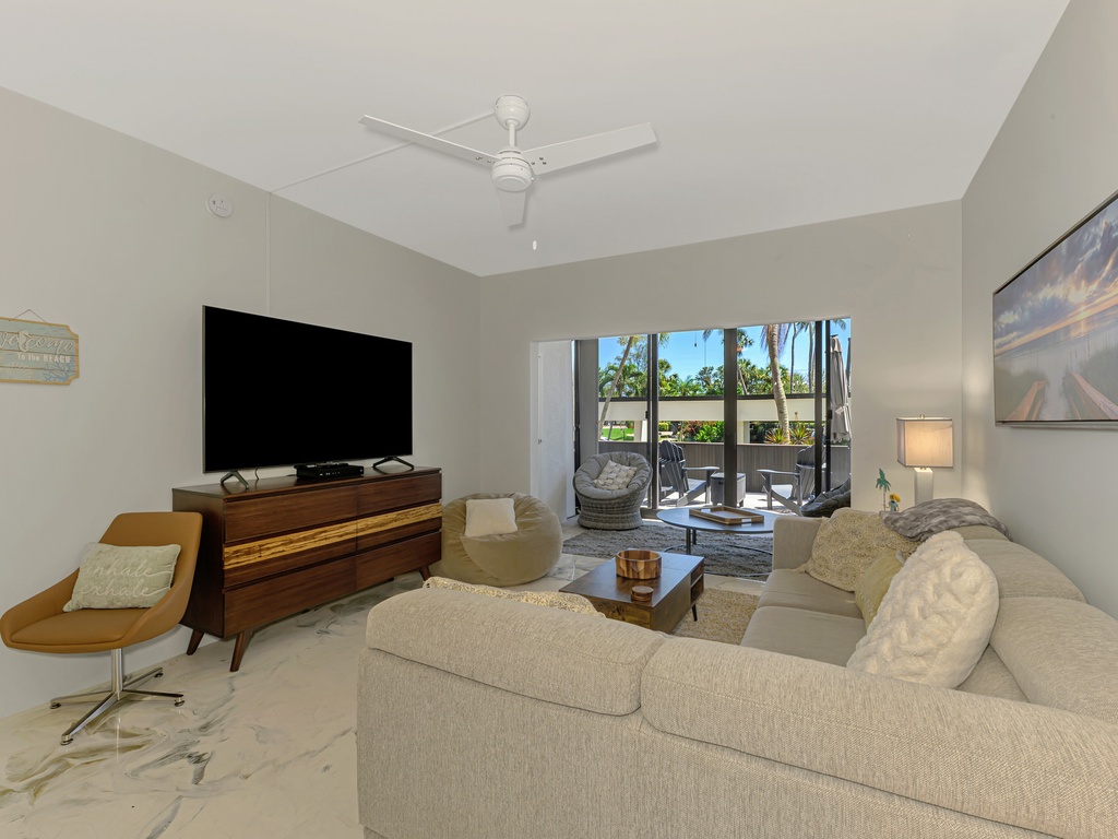 Sink into plush seating while enjoying your favorite shows on the large TV, with tropical views beckoning from your private balcony.