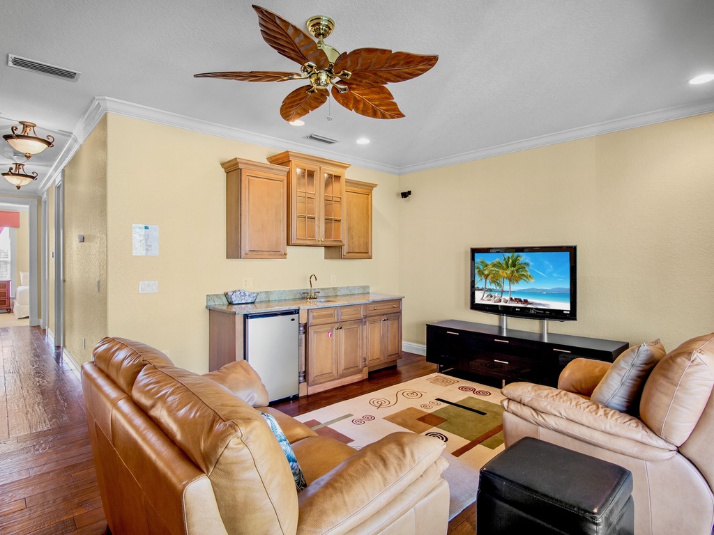 Second living room area with plush seating, kitchenette, and TV