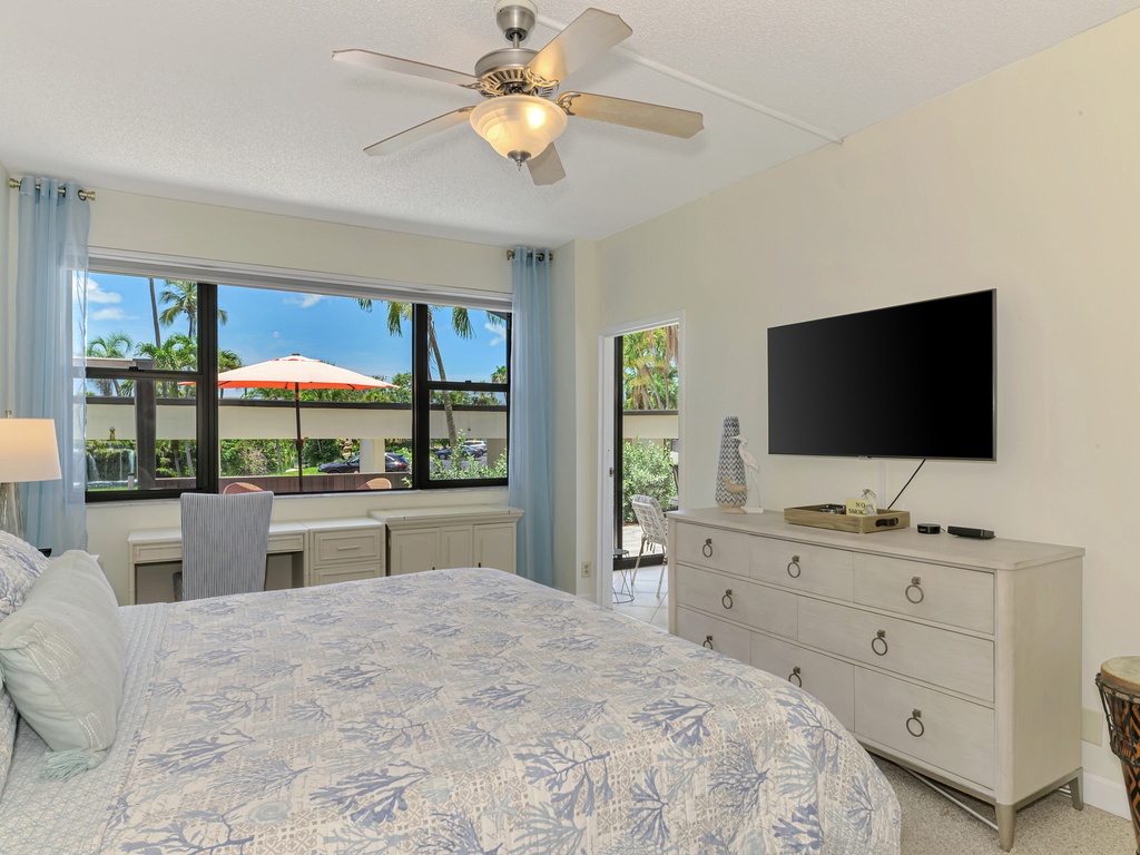 Relax in your serene bedroom featuring tropical views, modern amenities, and comfortable furnishings for the perfect getaway retreat.
