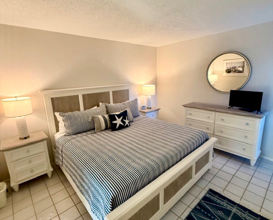 Rest peacefully in your comfortable bedroom with crisp nautical bedding, warm lighting, and thoughtful furnishings creating the perfect coastal retreat atmosphere.