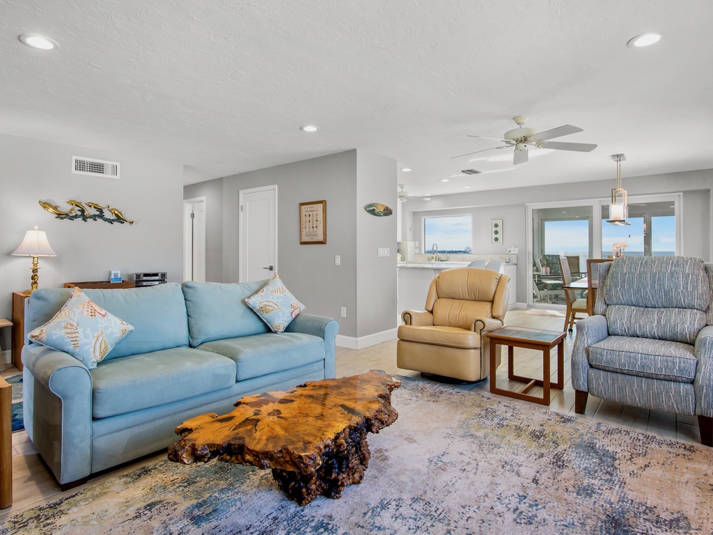 Sink into plush seating while ocean breezes flow through your bright, coastal living room featuring stunning sea views and thoughtful touches.