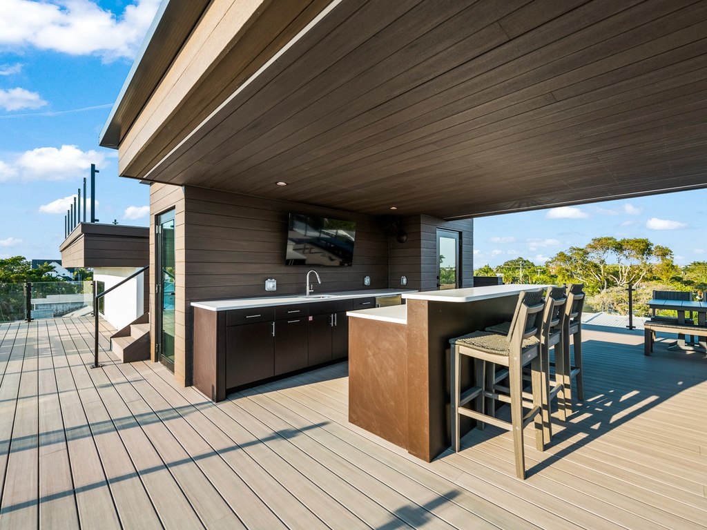 Rooftop bar area with TV for entertainment