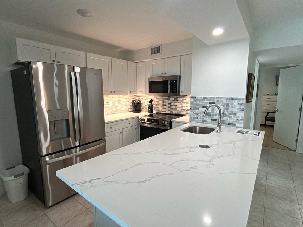 Cook your favorite meals in this stunning modern kitchen featuring granite countertops, stainless steel appliances, and ample prep space.