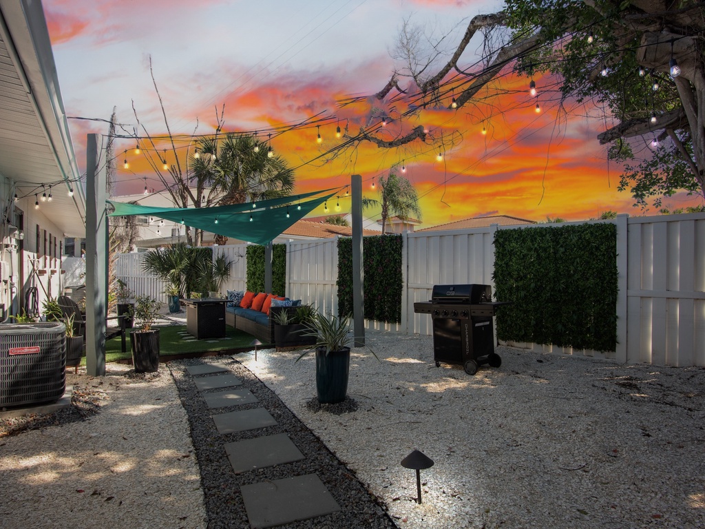 Shared backyard with comfortable seating and BBQ grill