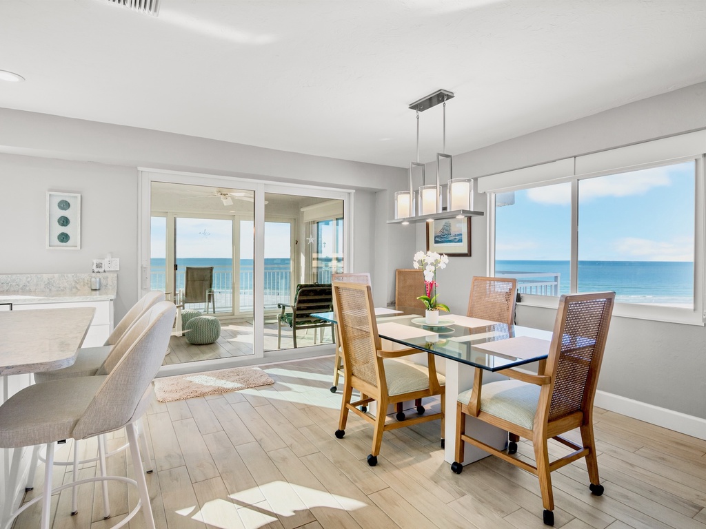 Your oceanfront dining room offers stunning sea views while you enjoy meals at the elegant glass table.