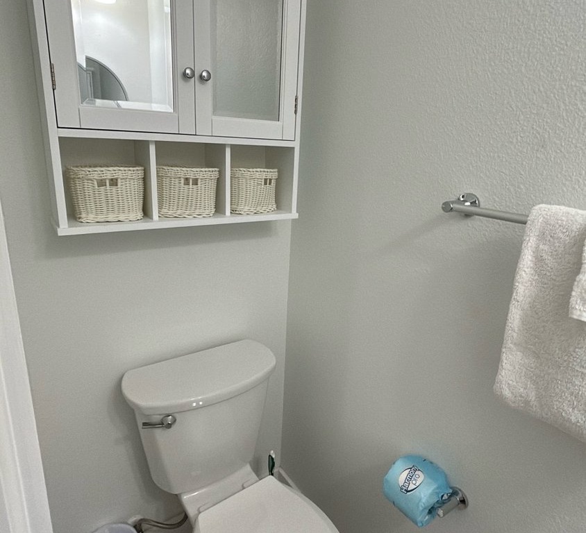 Your private bathroom features thoughtful storage with wicker baskets and a clean, comfortable design.