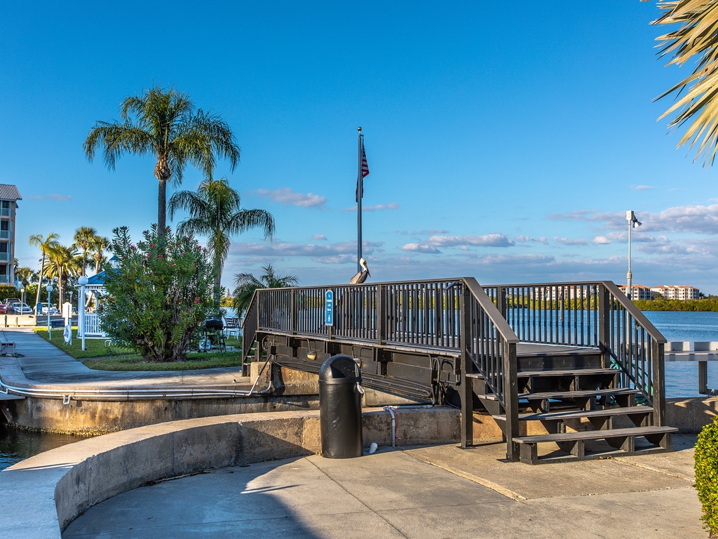 Waterfront boardwalk with marina access and tropical palms creates an inviting coastal setting for your Florida getaway.