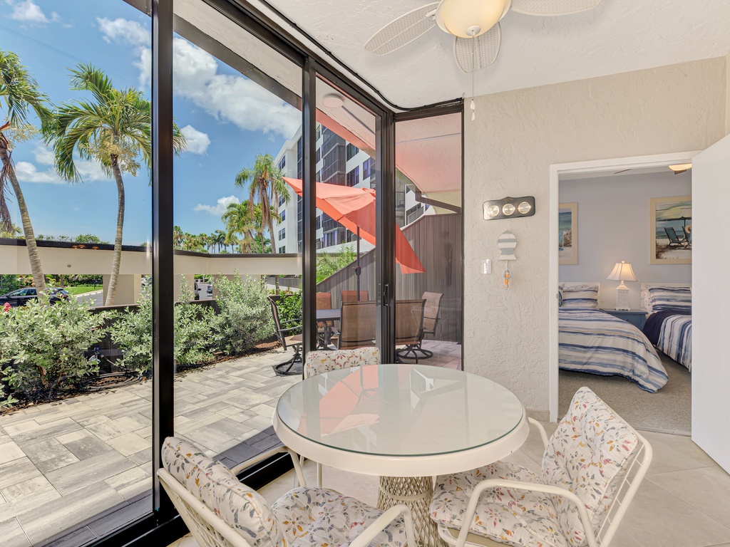 Enjoy morning coffee at your private dining nook with tropical garden views and seamless access to your outdoor terrace.