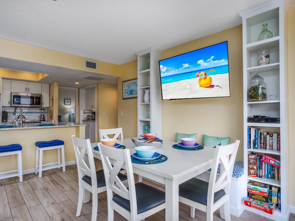 Your coastal retreat features an open dining area with beach views on TV, perfect for family meals and game nights.