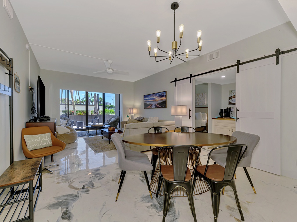 Unwind in your stylish open-plan living space with modern furnishings, elegant lighting, and sleek marble floors creating the perfect atmosphere for relaxation.
