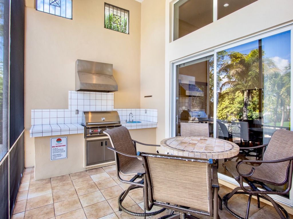 Screened-in lanai with built-in BBQ and dining area