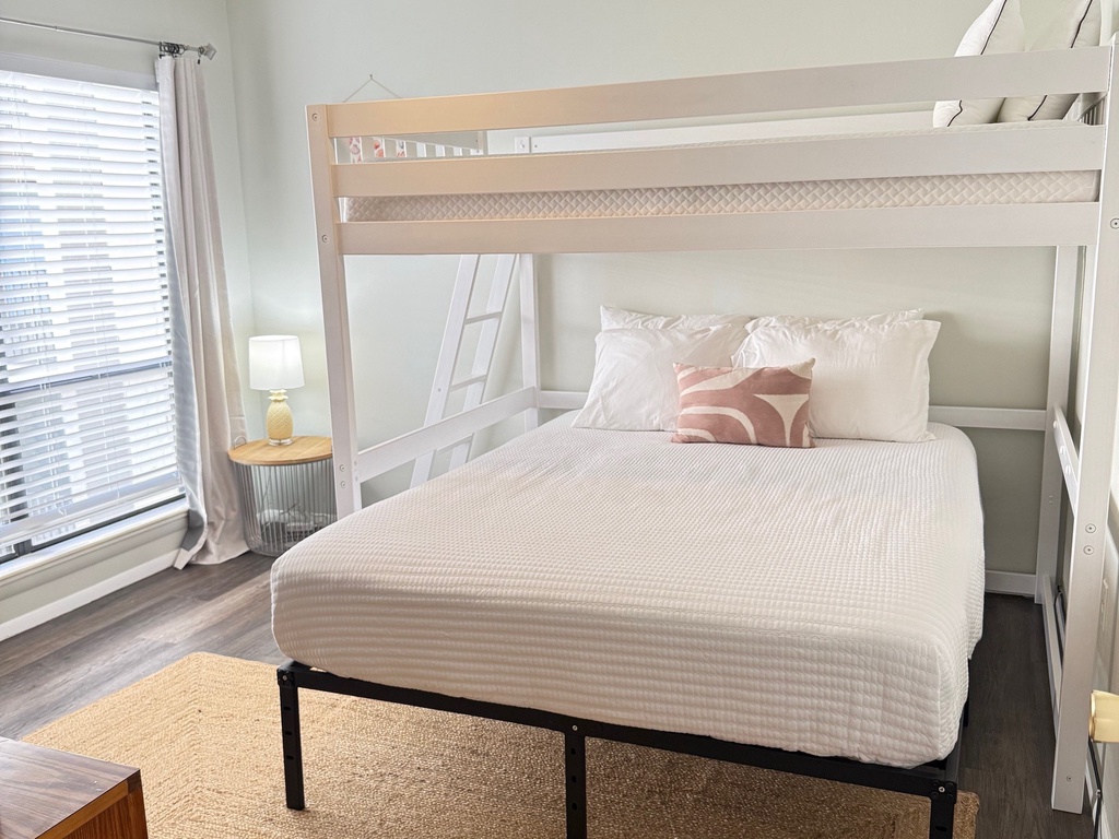 Second Bedroom features a modern white bunk bed with crisp linens, perfect for families or groups traveling together.